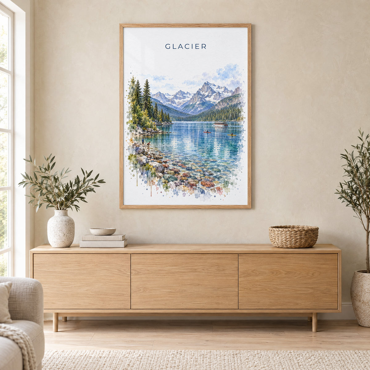Glacier National Park watercolor print in an oak frame above a light wood sideboard in a Scandinavian living room