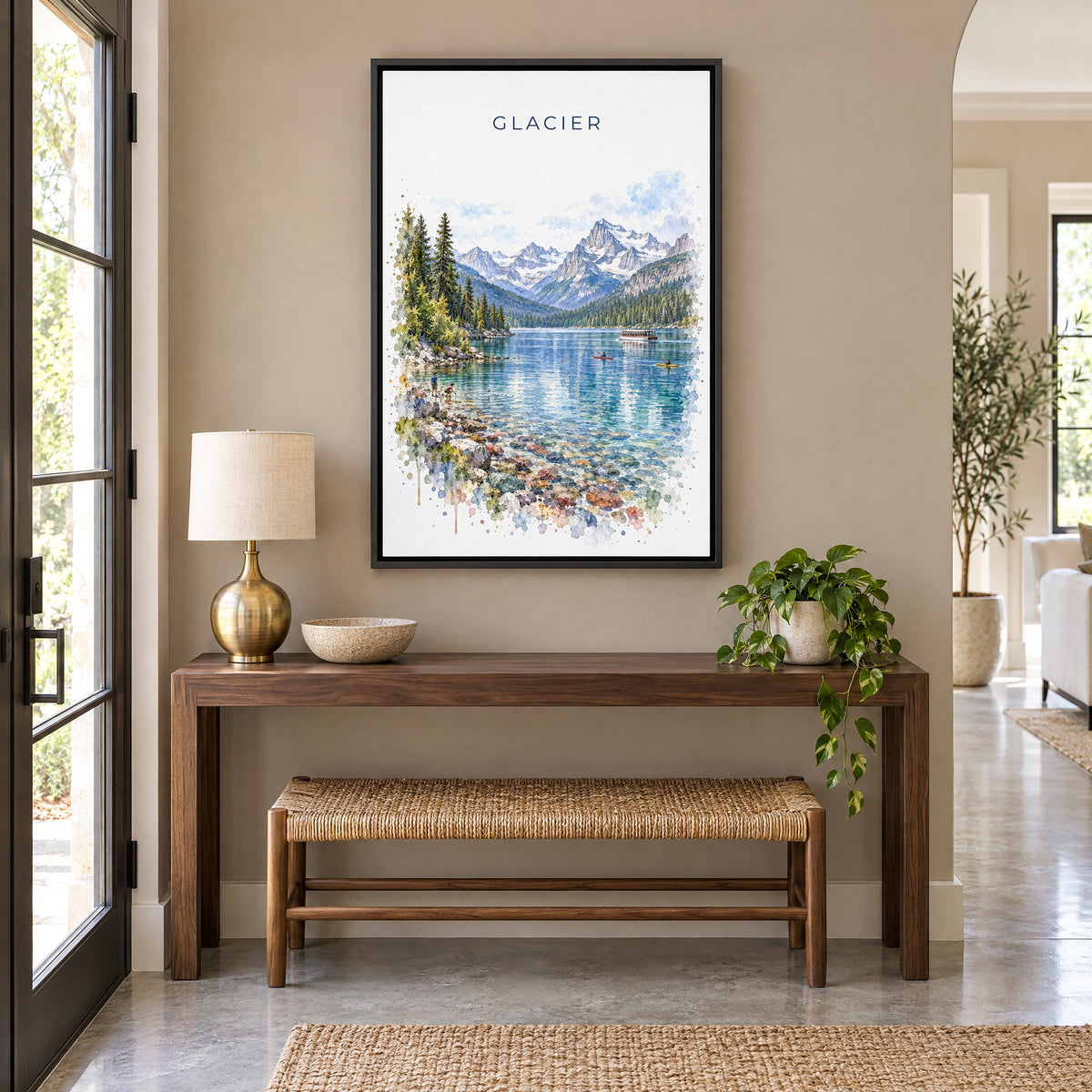 Glacier National Park watercolor print as a black floater canvas above a walnut console and woven bench in an entryway