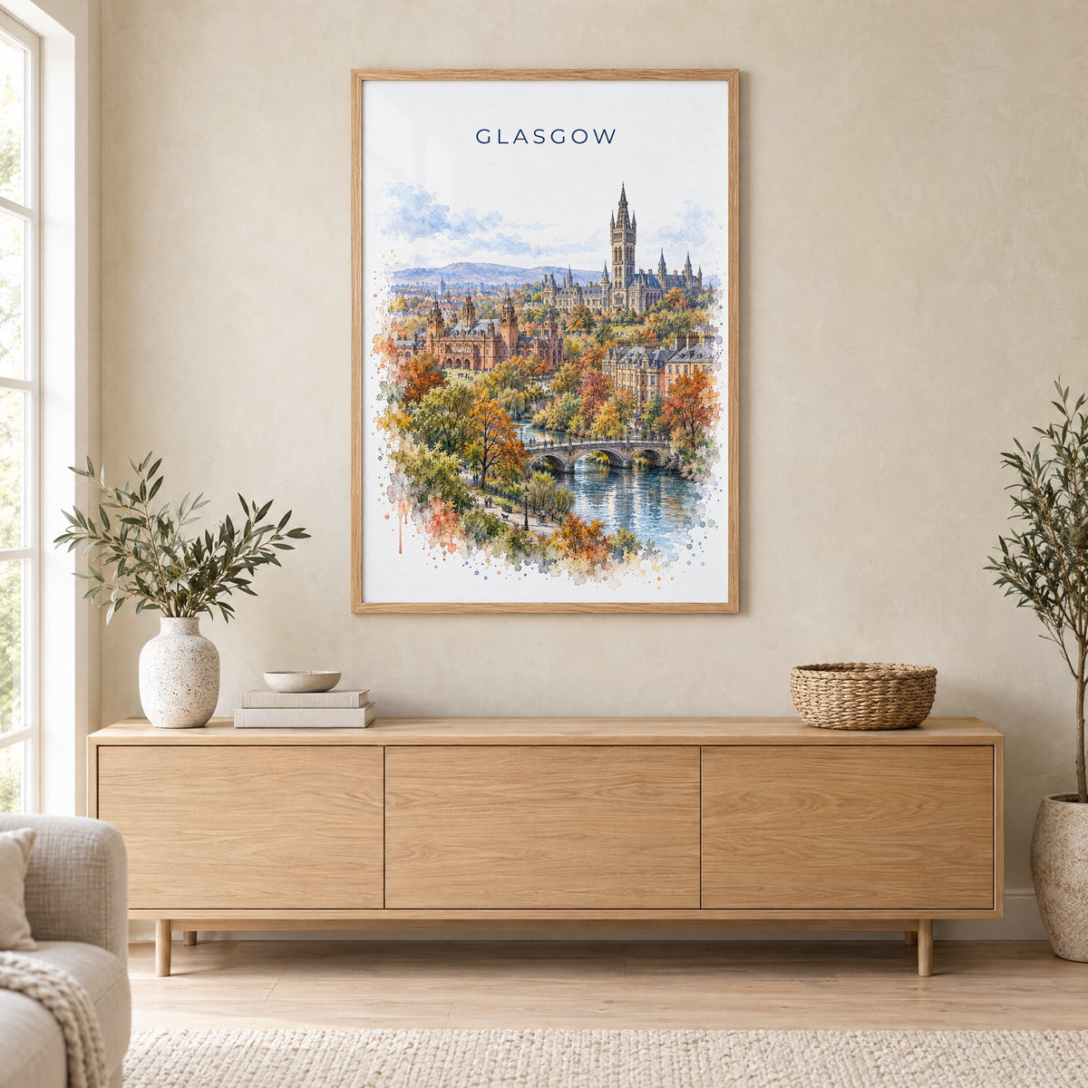 Glasgow watercolor print in an oak frame above a light wood sideboard in a Scandinavian living room
