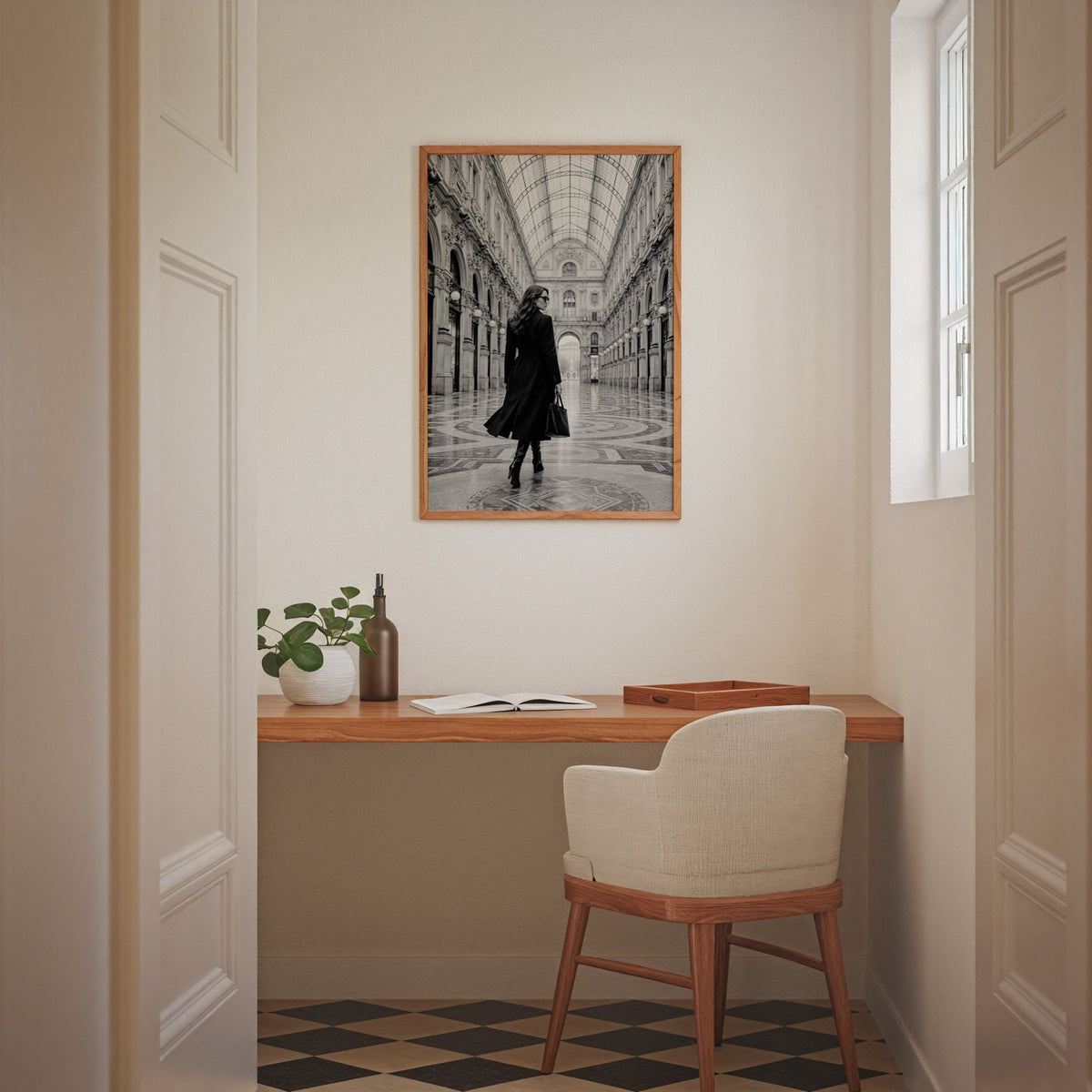 Black and white woman in a glass arcade print in an oak frame above a home office desk nook