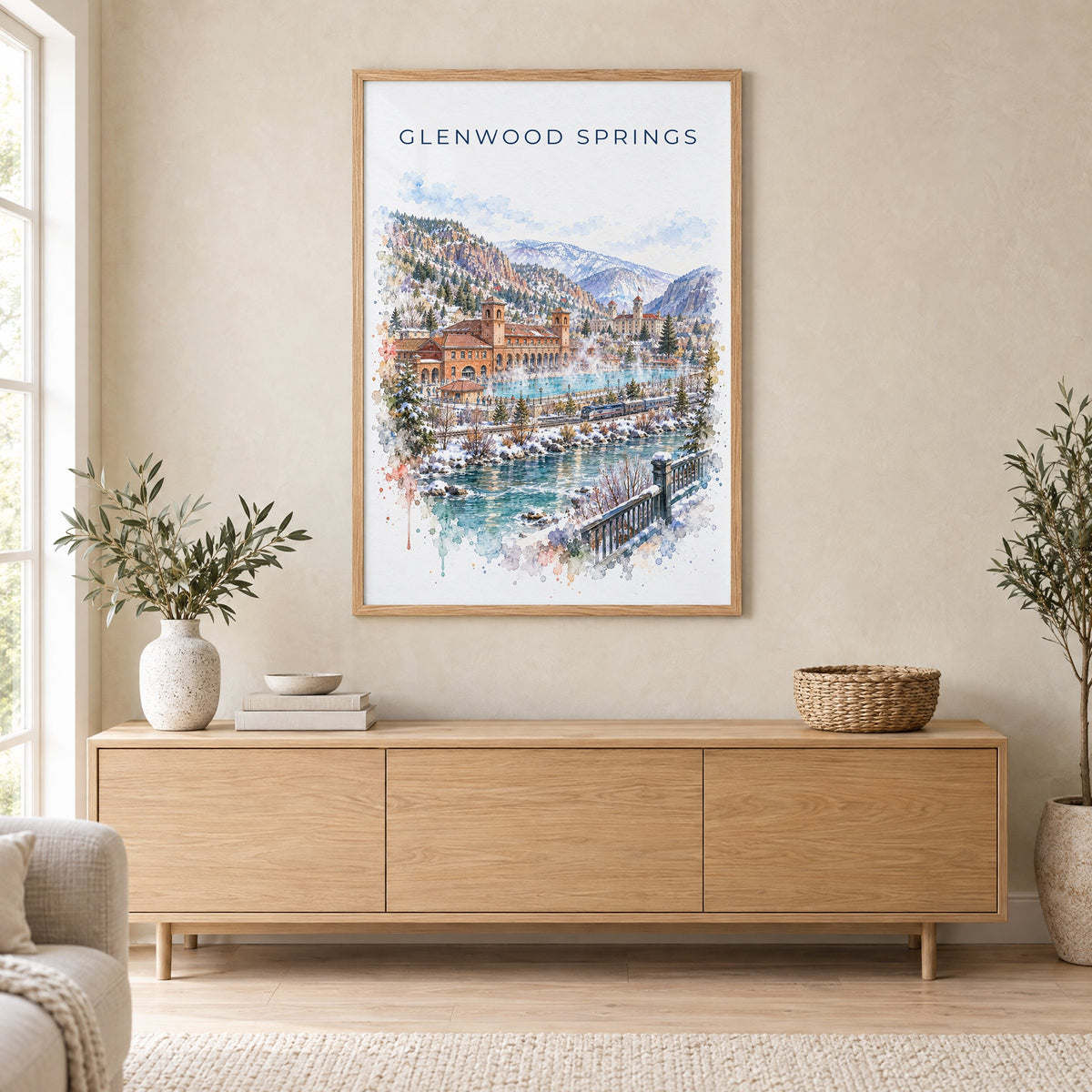 Glenwood Springs watercolor print in an oak frame above a light wood sideboard in a Scandinavian living room