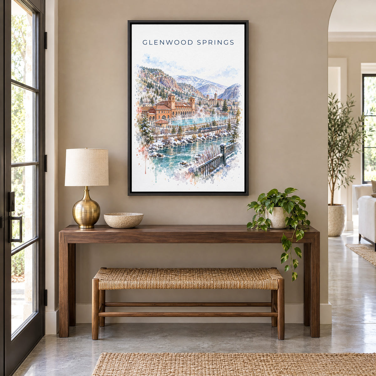 Glenwood Springs watercolor print as a black floater canvas above a walnut console and woven bench in an entryway