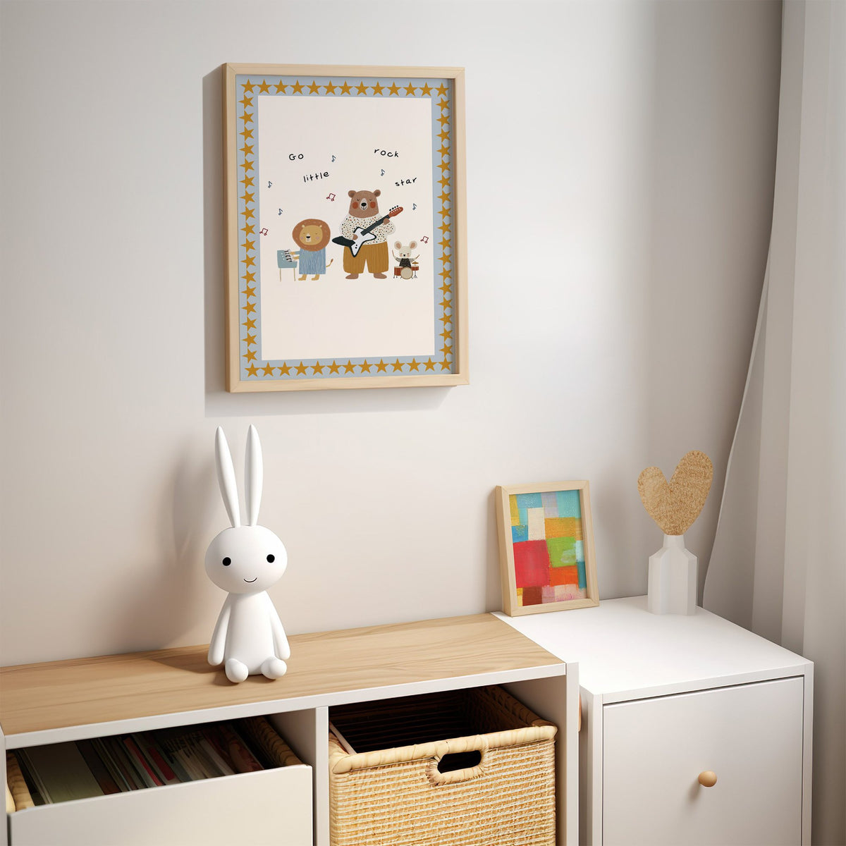 Go little rock star band nursery print in an oak frame above a kids cubby shelf with a woven basket and bunny lamp