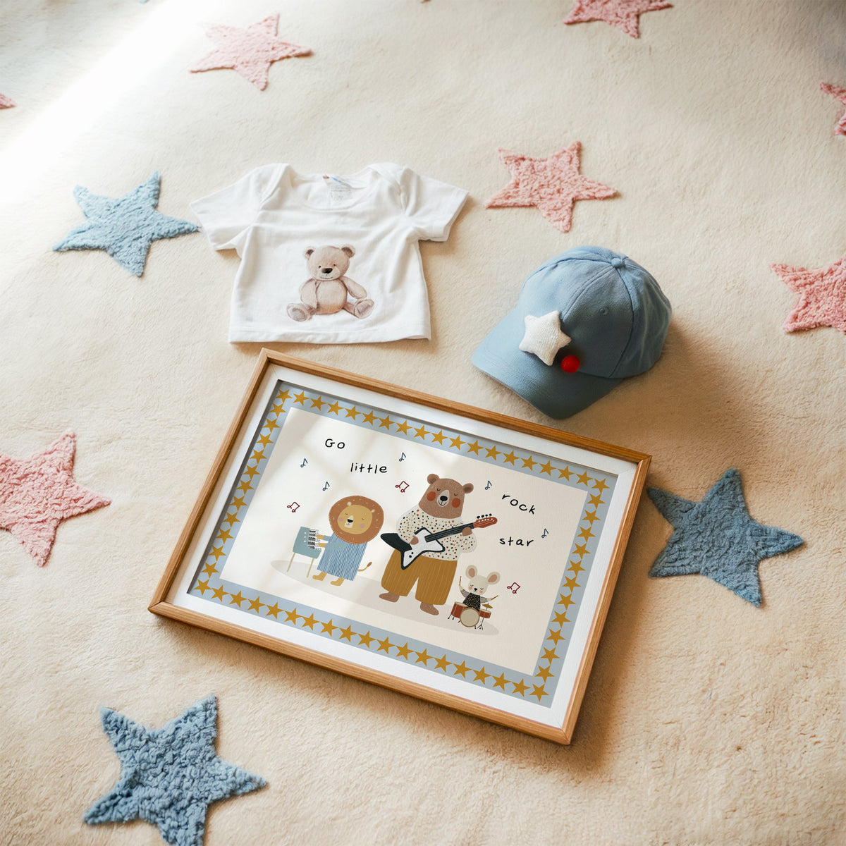 Landscape go little rock star band nursery print in a matted oak frame on a star rug with a baby tee