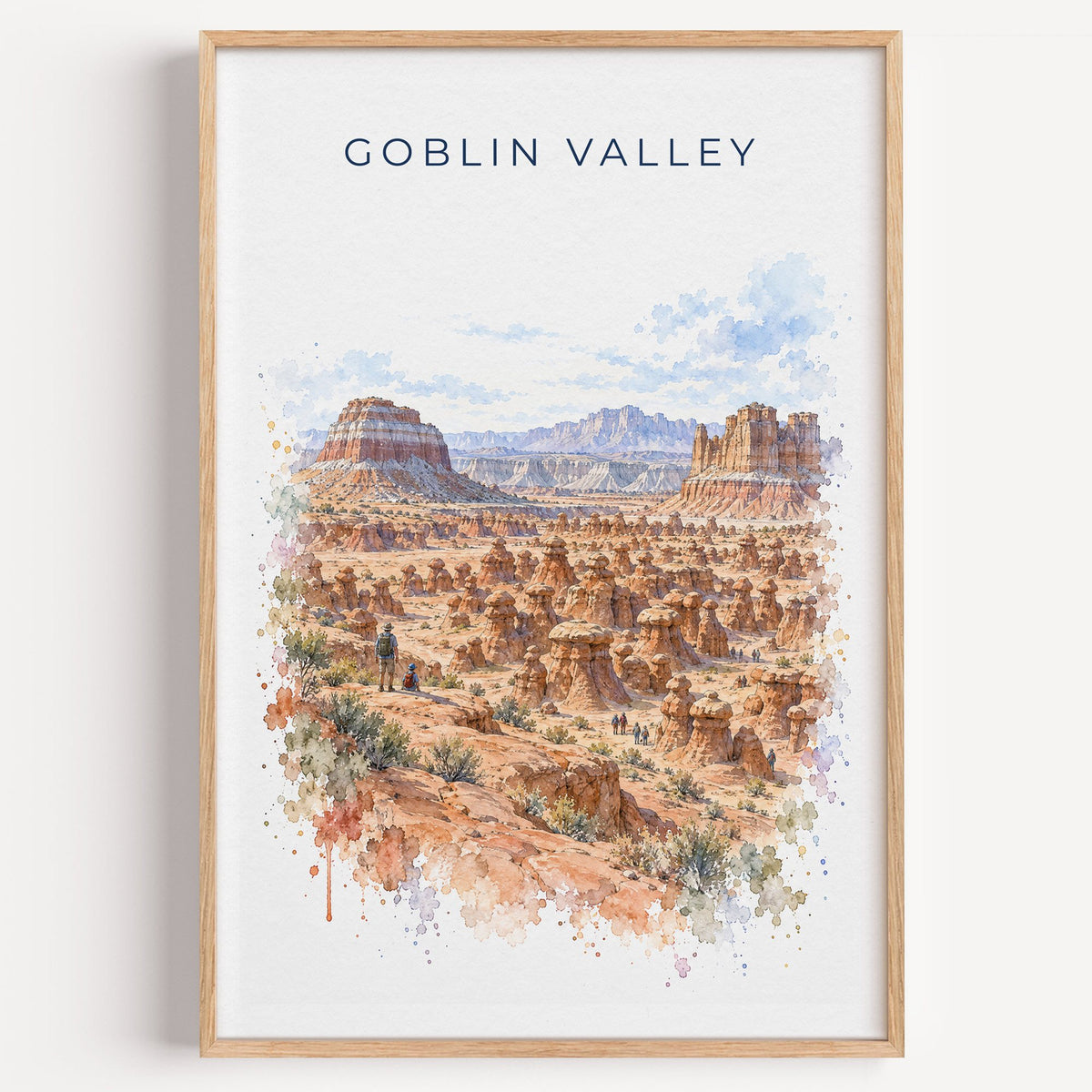 Goblin Valley State Park watercolor print in a light oak frame on a plain white wall