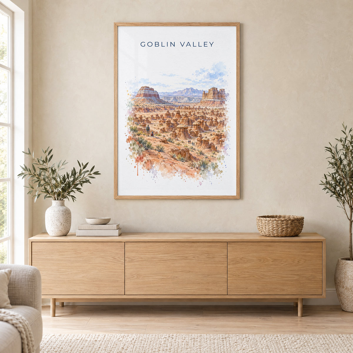 Goblin Valley State Park watercolor print in an oak frame above a light wood sideboard in a Scandinavian living room