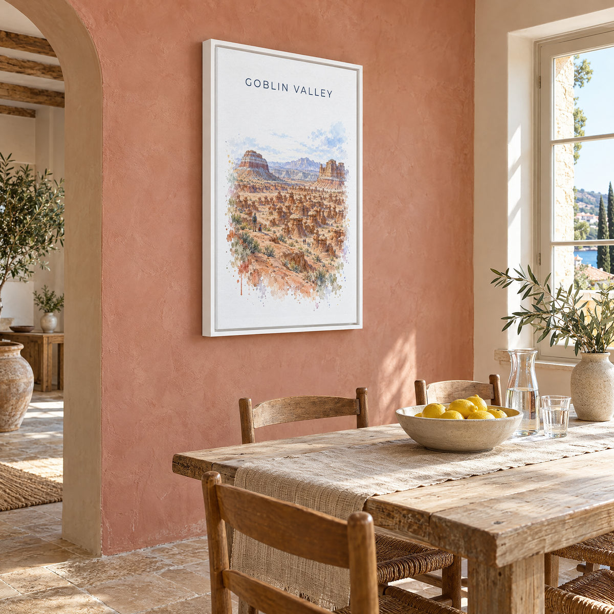 Goblin Valley State Park watercolor print as a white floater canvas on a terracotta wall above a rustic dining table