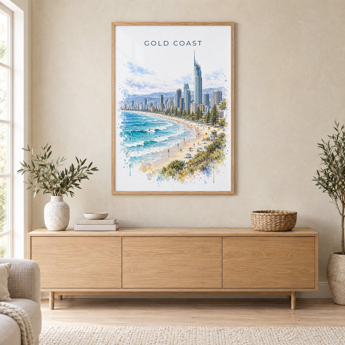 Gold Coast watercolor print in an oak frame above a light wood sideboard in a Scandinavian living room