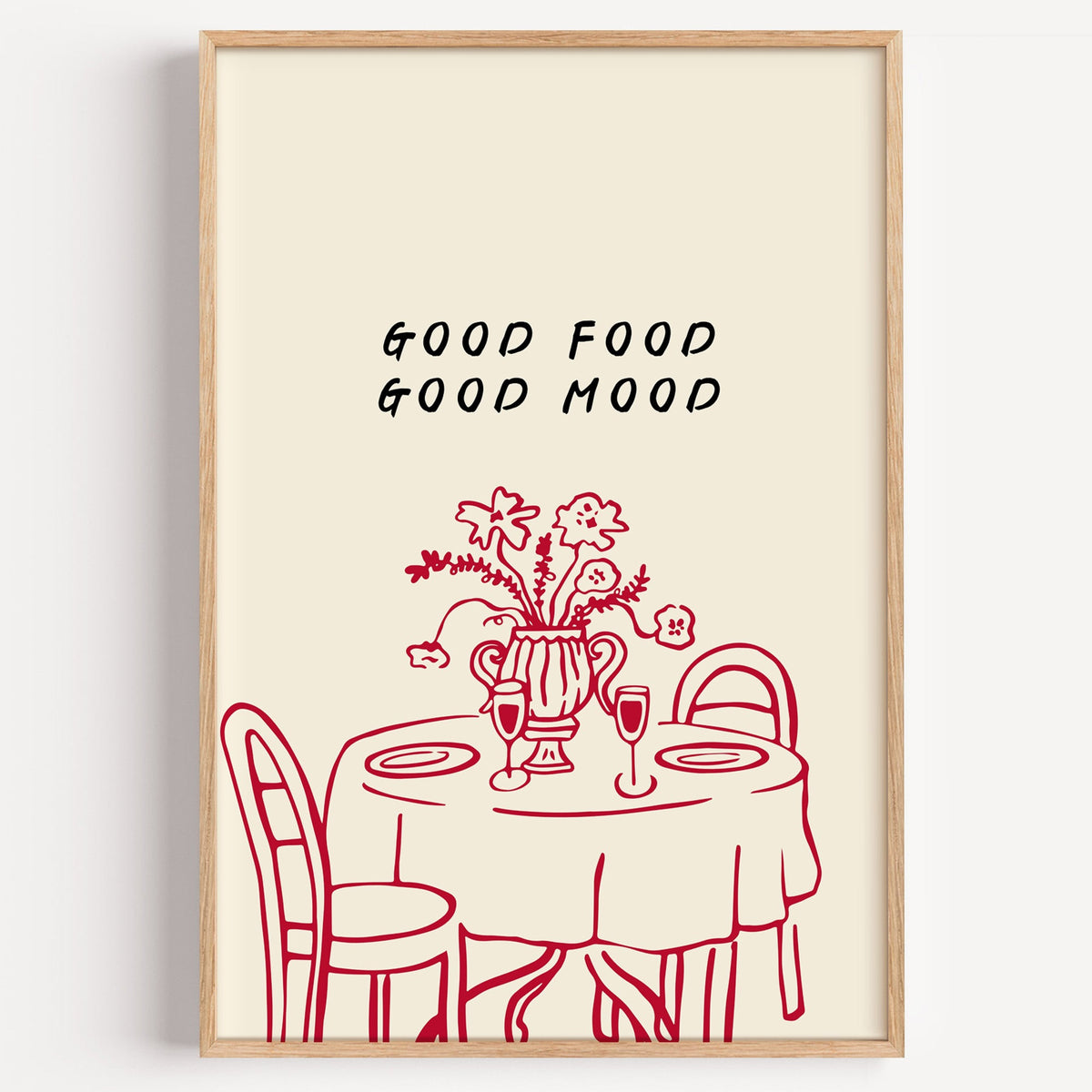 Good Food Good Mood bistro print in a light oak frame on a plain white wall