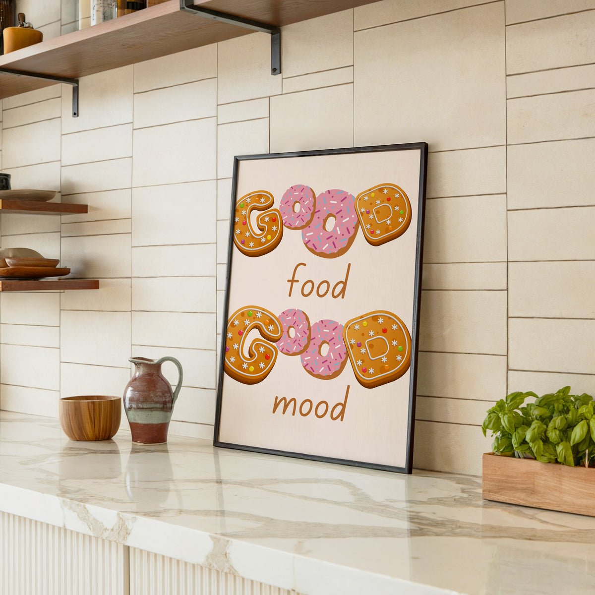 Good Food Good Mood donut print in a black frame leaning on a marble counter in a tiled kitchen