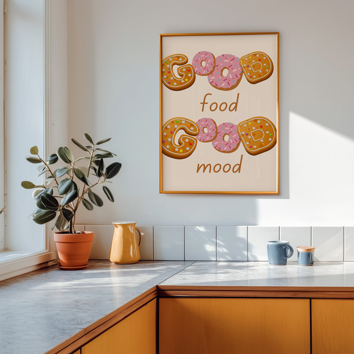 Good Food Good Mood donut print shown in a gold frame above a marble counter in a tan kitchen