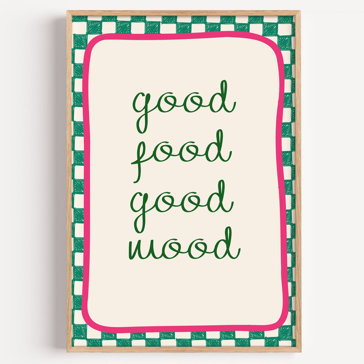 Good food good mood checkered print in a light oak frame on a plain white wall