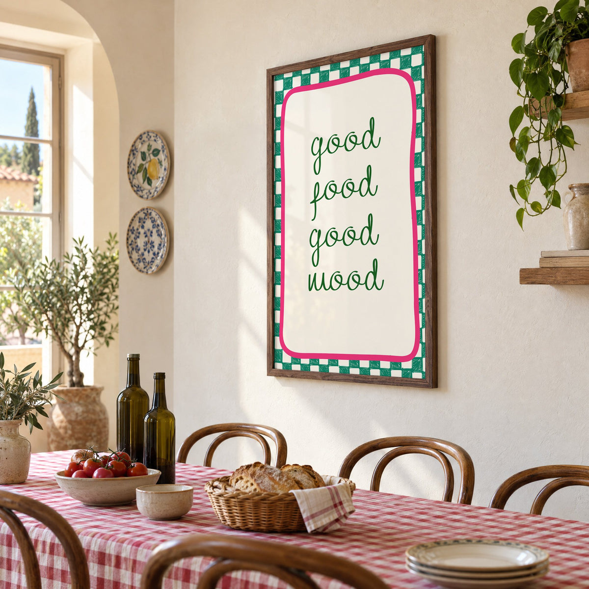 Good food good mood checkered print in a walnut frame above a gingham-covered trattoria table, seen at an angle