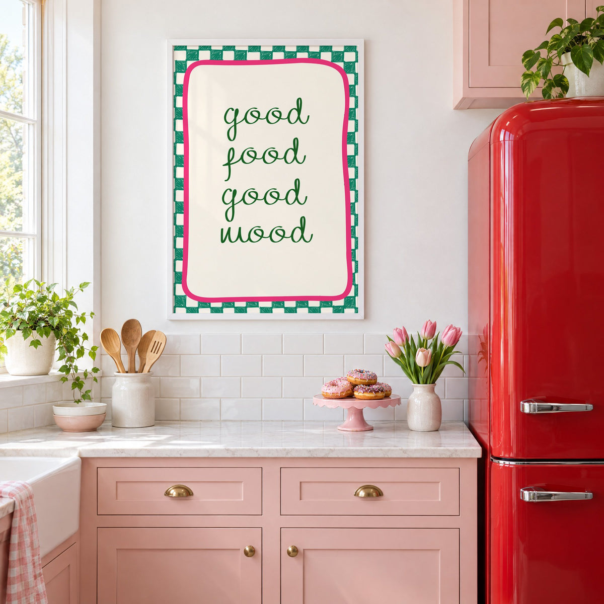 Good food good mood checkered print in a white frame in a pink kitchen beside a red retro fridge