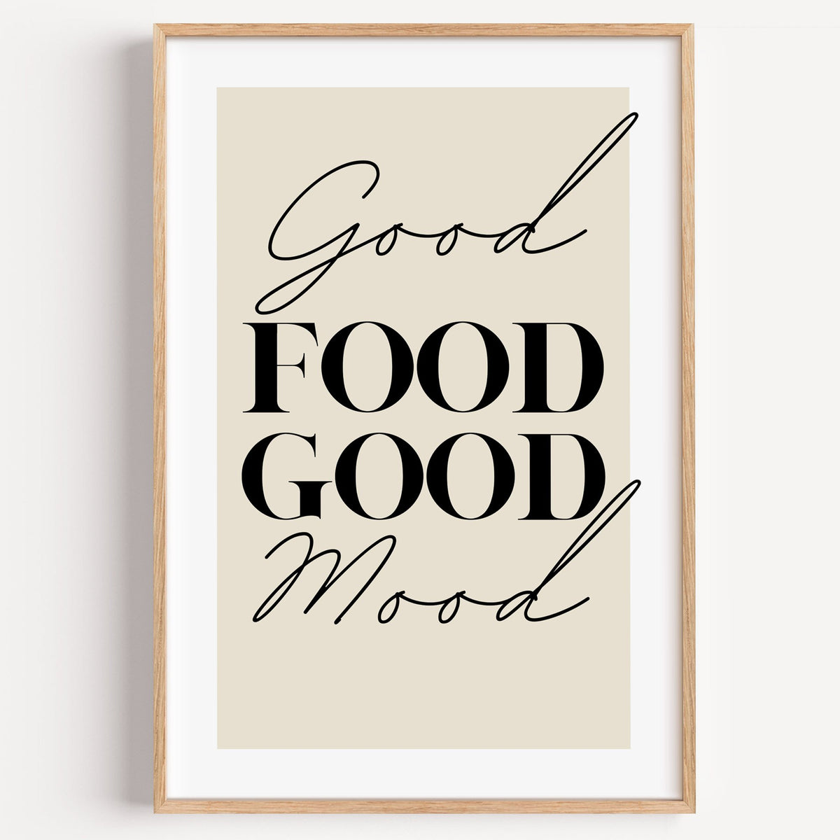 Good FOOD GOOD Mood serif script print in a light oak frame on a plain white wall