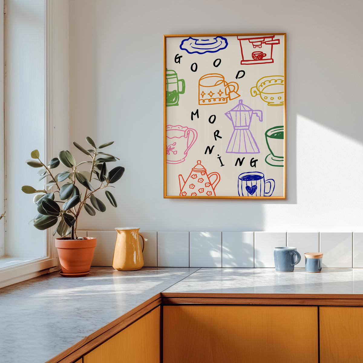 Good Morning coffee print shown in a gold frame above a marble counter with a yellow ceramic jug