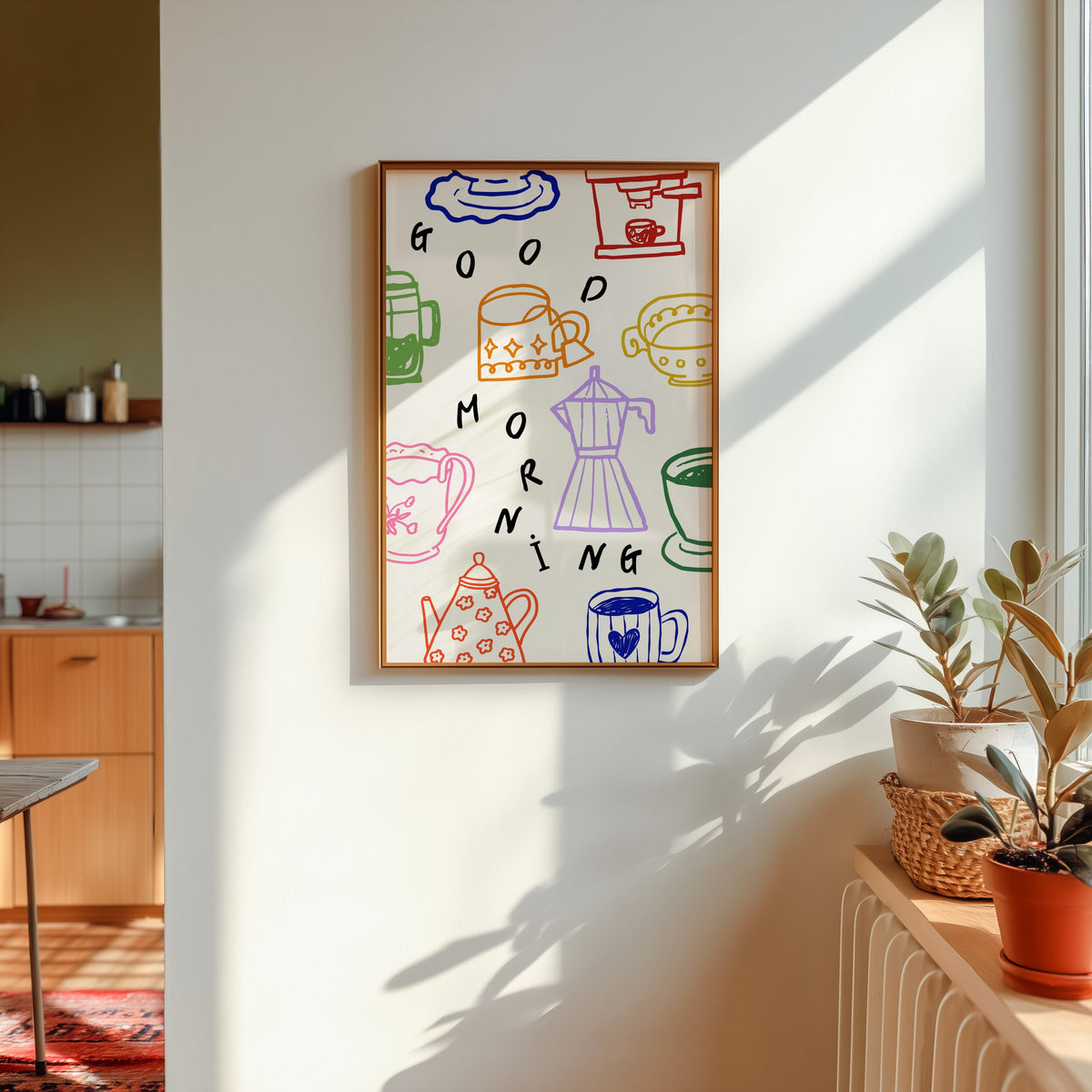 Good Morning coffee print shown in a gold frame in sunlight with plants and a kitchen beyond