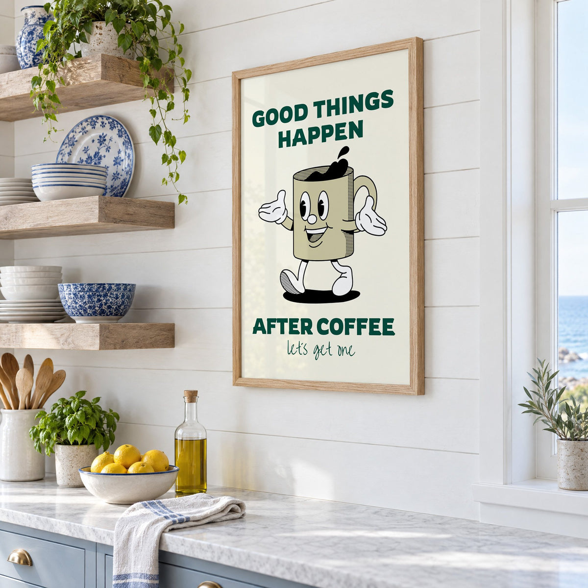 Good Things Happen After Coffee mug print in an oak frame in a white coastal kitchen beside blue and white plates
