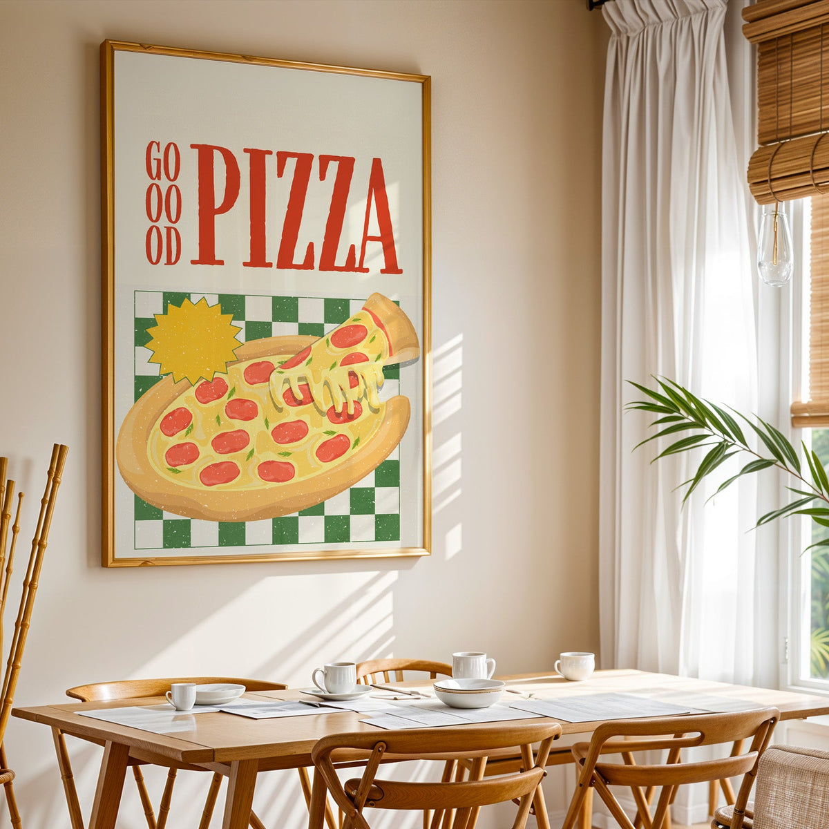 Goood Pizza print shown in a gold frame above a breakfast table by a curtained window