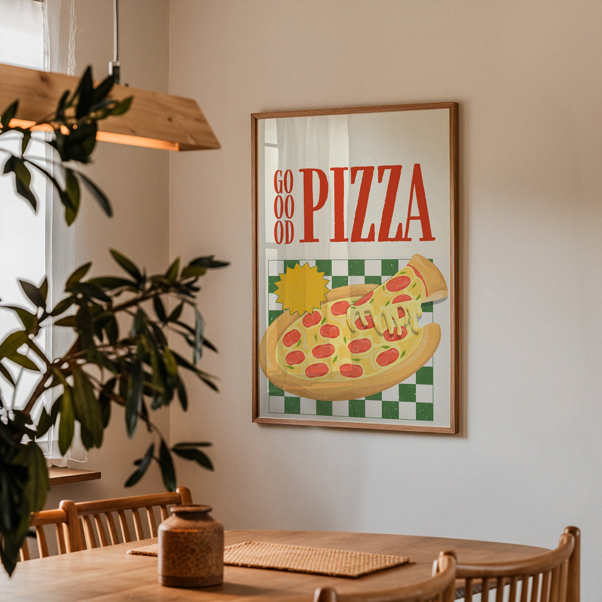 Goood Pizza print in a walnut frame above a dining table with olive branches