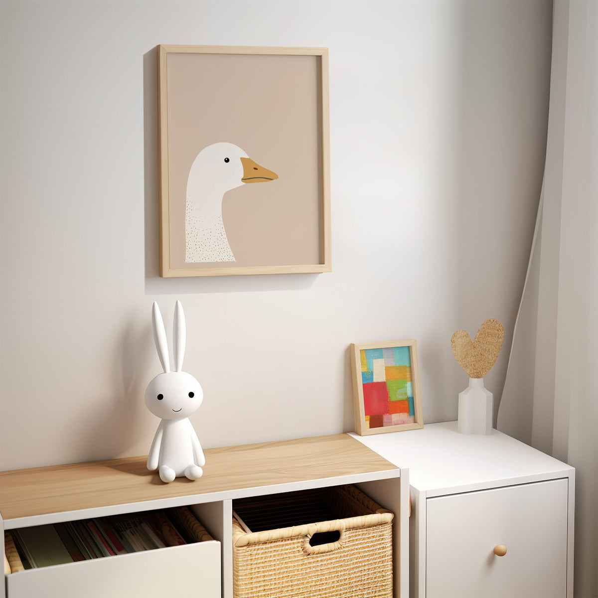 Goose head profile nursery print in an oak frame above a kids cubby shelf with a woven basket and bunny lamp