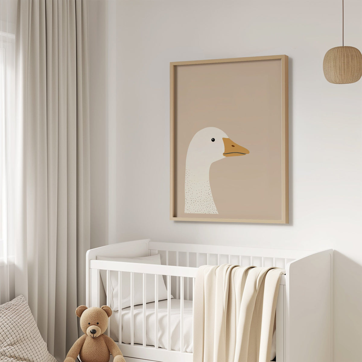Goose head profile nursery print in an oak frame above a white crib with a teddy bear