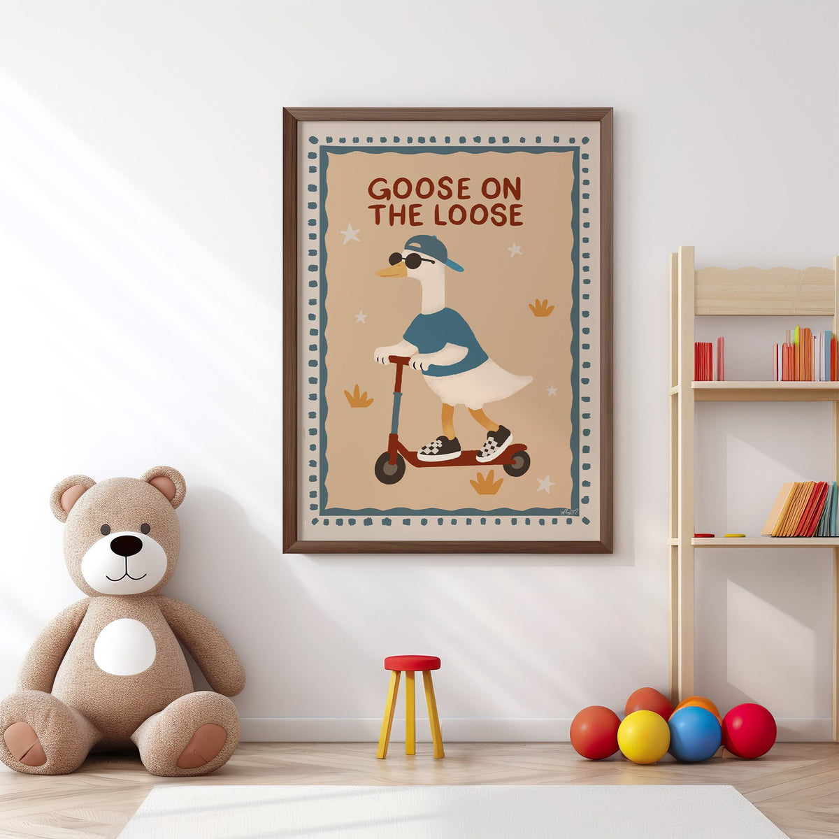 Goose on the loose scooter nursery print in a walnut frame above a big teddy bear by a bookshelf