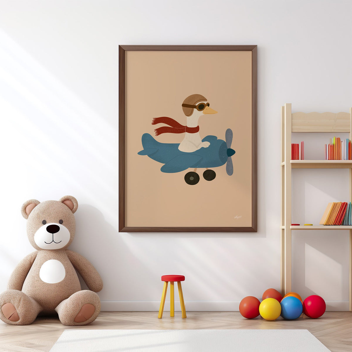 Goose pilot in blue airplane nursery print in a walnut frame above a big teddy bear by a bookshelf