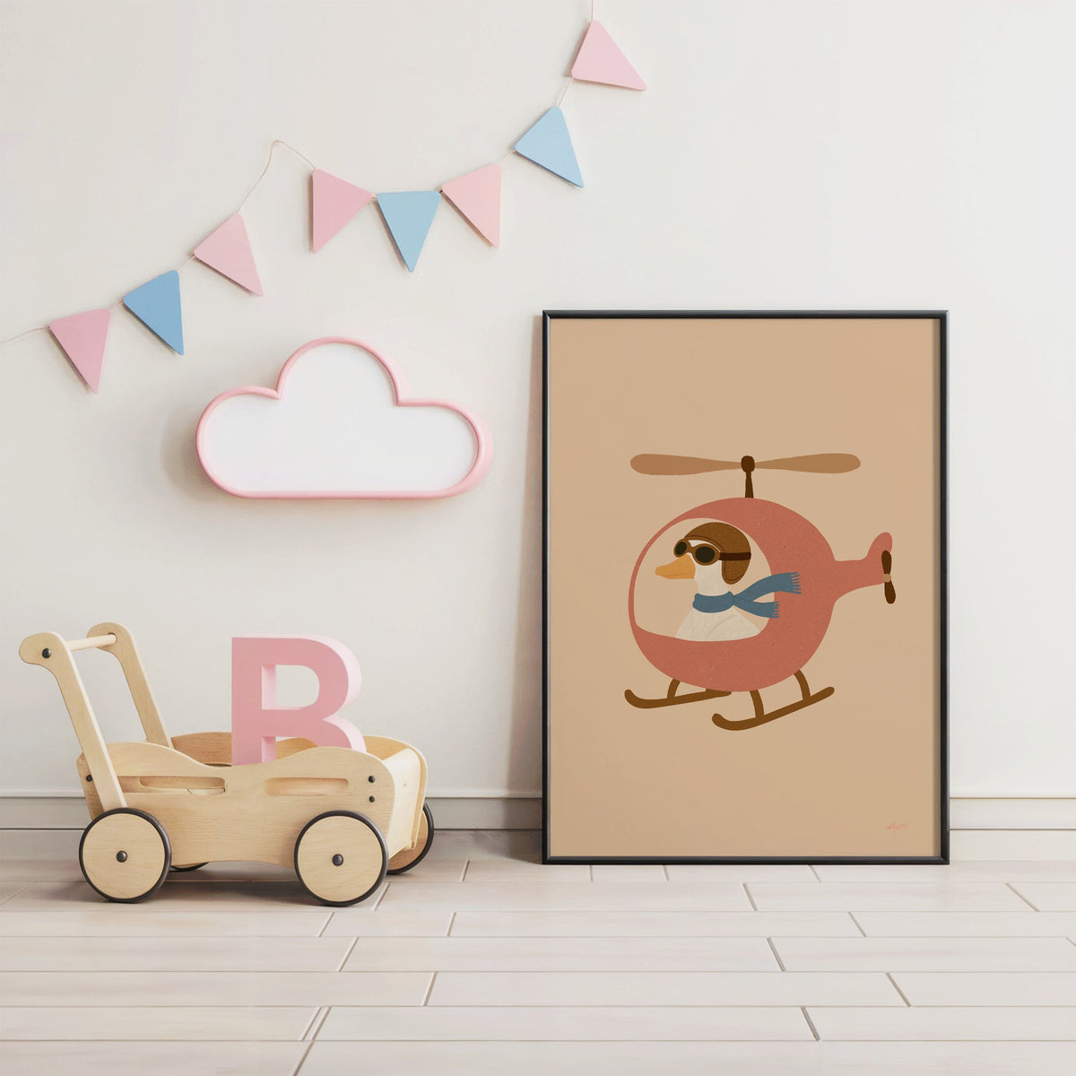 Goose pilot in pink helicopter nursery print in a black frame under pastel bunting by a wooden baby walker