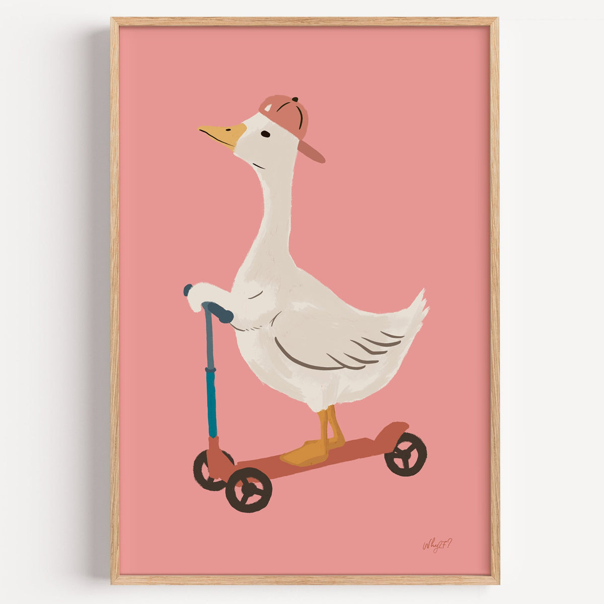 Goose on scooter in pink cap nursery print in a light oak frame on a plain white wall