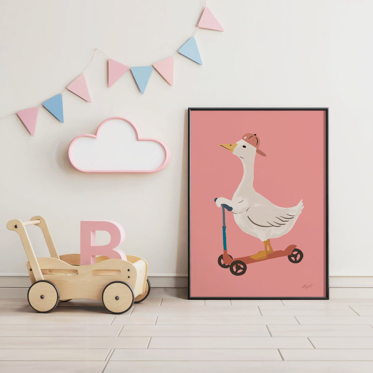 Goose on scooter in pink cap nursery print in a black frame under pastel bunting by a wooden baby walker