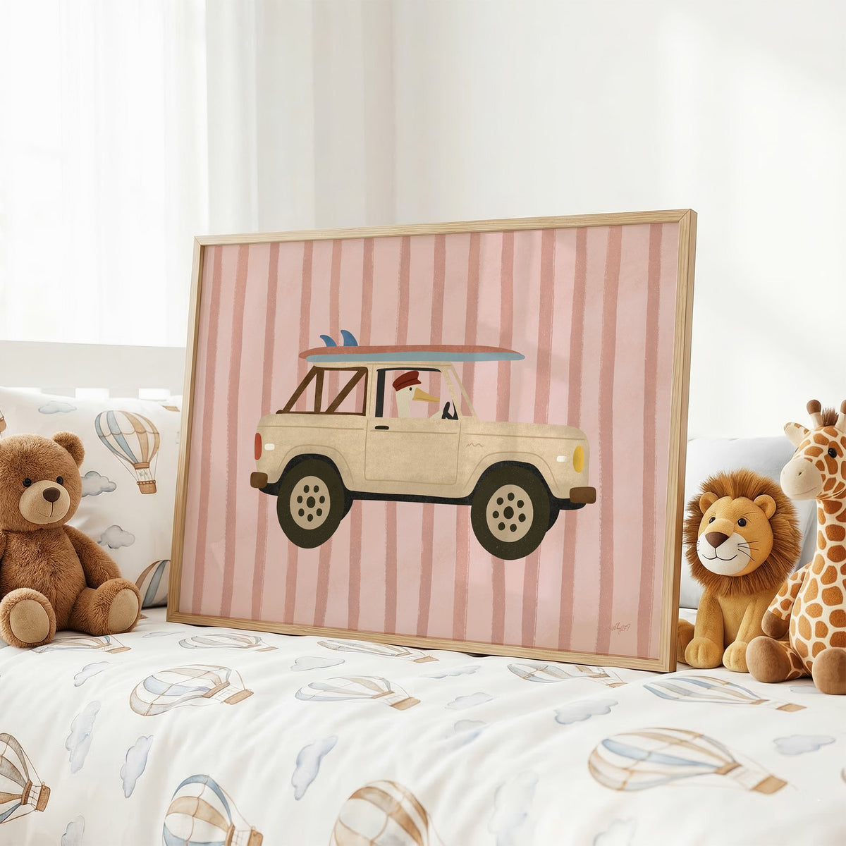 Goose driving cream surf truck nursery print in an oak frame on a kids bed with hot air balloon bedding