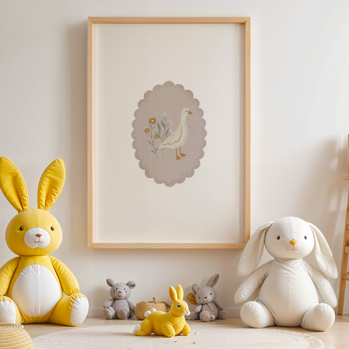 White goose and wildflowers in scalloped oval nursery print in an oak frame above yellow and white plush bunnies