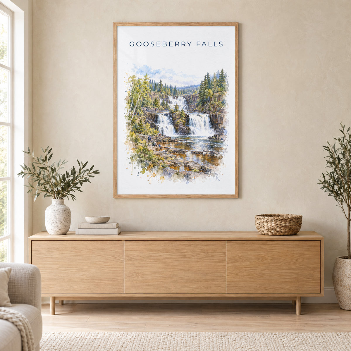 Gooseberry Falls State Park watercolor print in an oak frame above a light wood sideboard in a Scandinavian living room