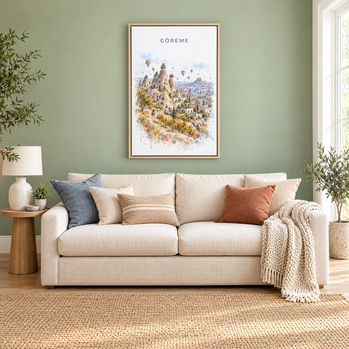Göreme watercolor print as a natural floater canvas above a cream linen sofa on a sage green wall