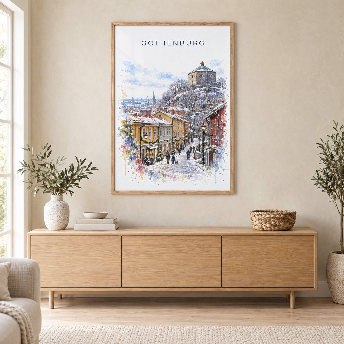 Gothenburg watercolor print in an oak frame above a light wood sideboard in a Scandinavian living room