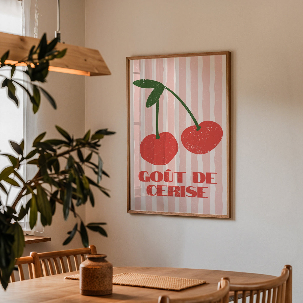 Gout de Cerise cherry print in a walnut frame above a dining table with olive branches