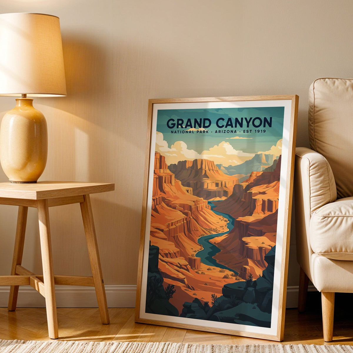 Grand Canyon print in an oak frame beside a cream armchair and an amber lamp in warm afternoon light