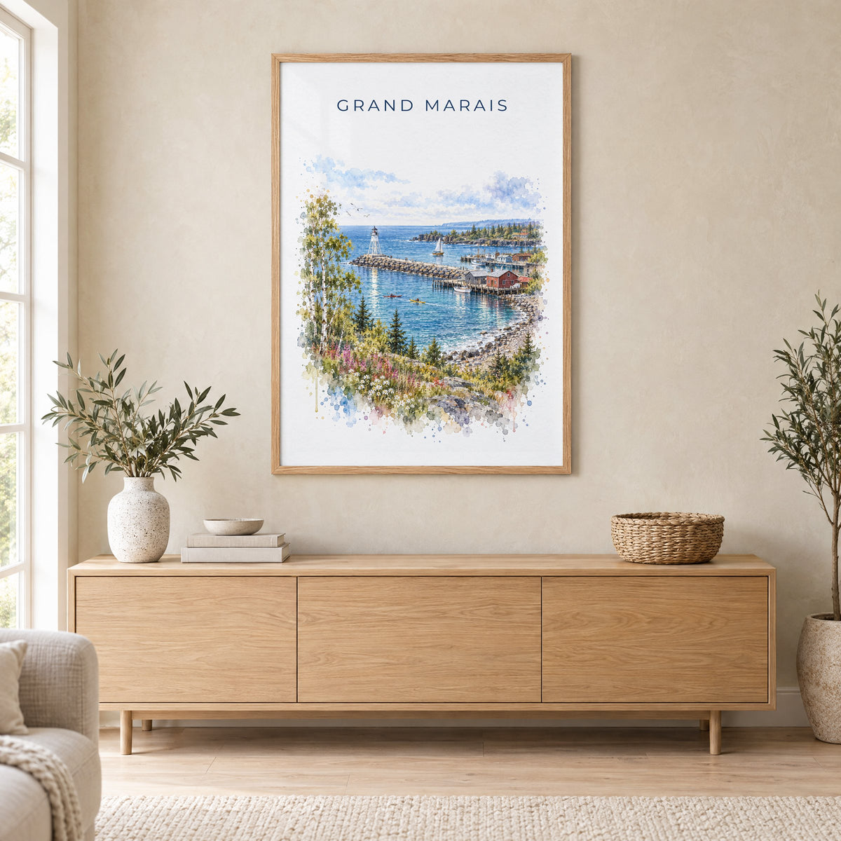 Grand Marais, Minnesota watercolor print in an oak frame above a light wood sideboard in a Scandinavian living room