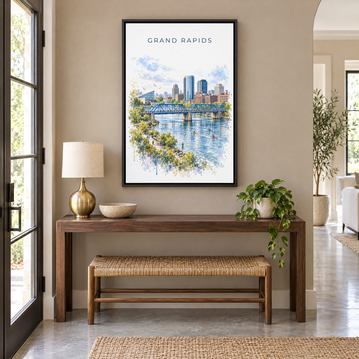 Grand Rapids watercolor print as a black floater canvas above a walnut console and woven bench in an entryway