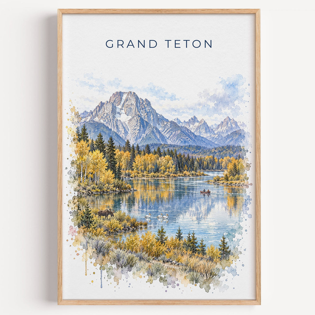 Grand Teton National Park watercolor print in a light oak frame on a plain white wall