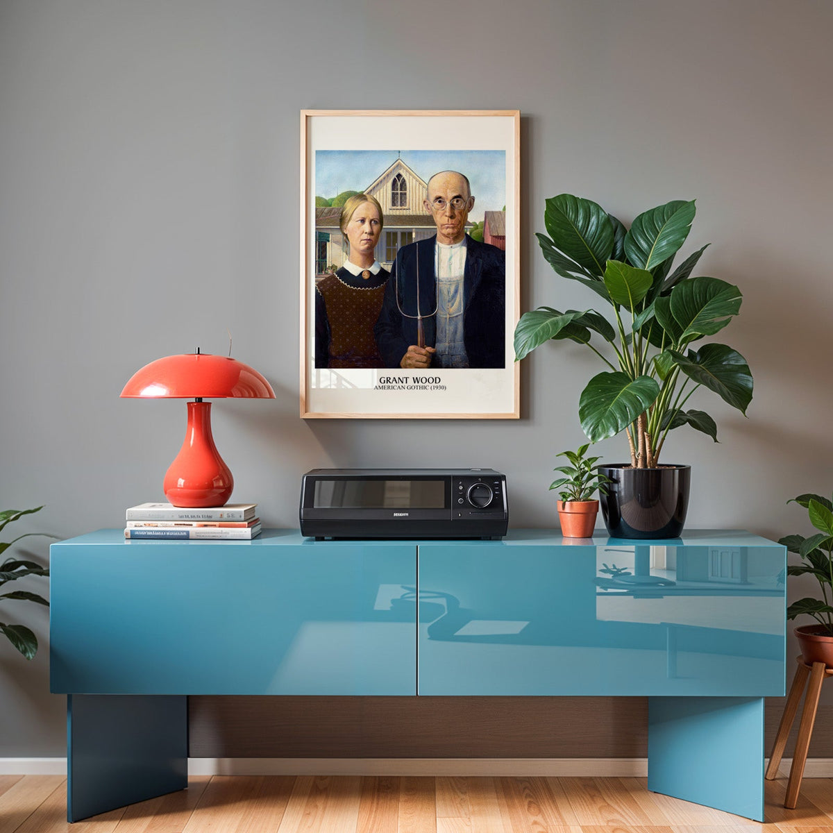 Grant Wood poster in an oak frame above a teal sideboard with a red lamp
