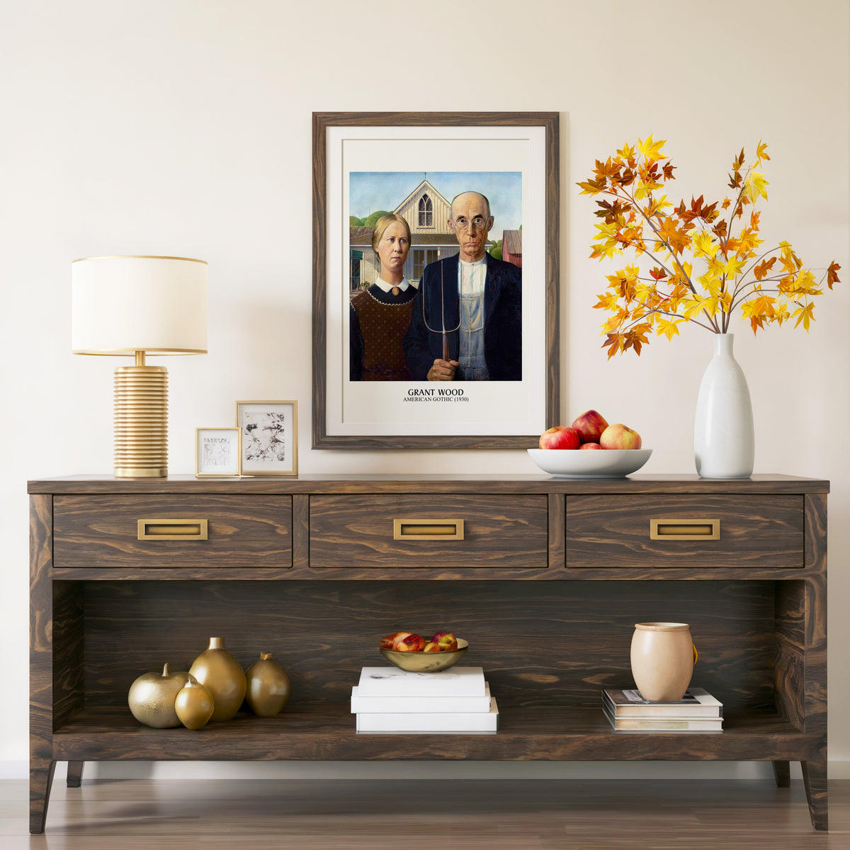 American Gothic print in a walnut frame above a console with autumn branches