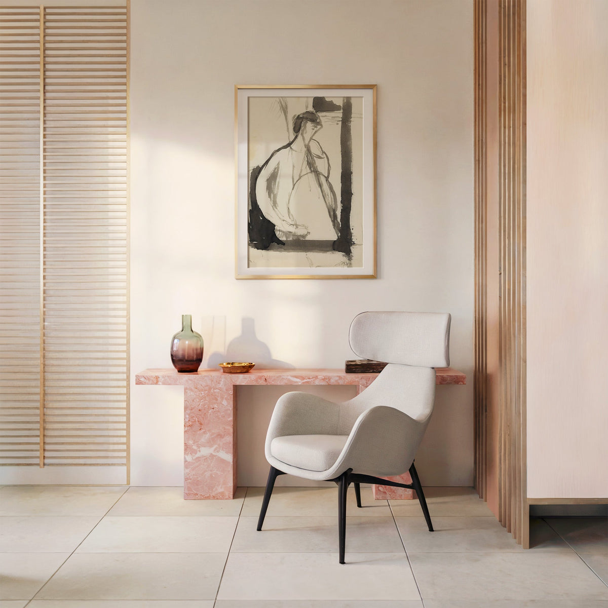 Gray ink seated woman figure sketch print shown in a gold frame with a mat above a pink marble console and armchair