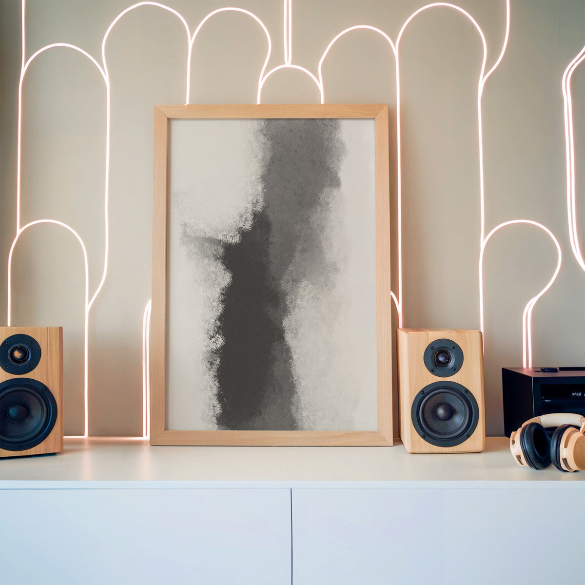 Gray ink smoke column minimalist abstract print in a pine frame between wooden speakers by a neon arch light wall