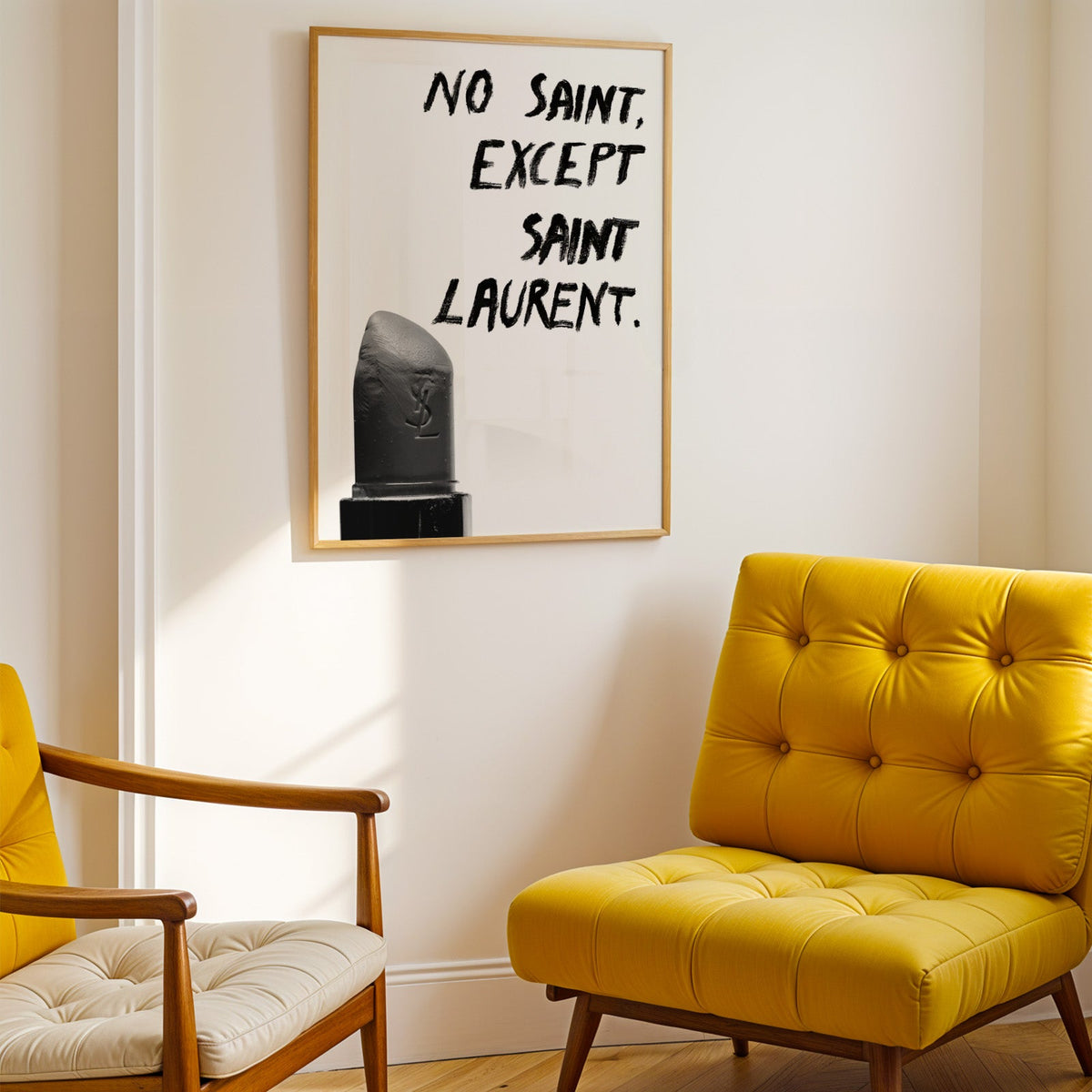 Gray lipstick with black brush lettering quote print shown in a gold frame above a mustard yellow tufted armchair