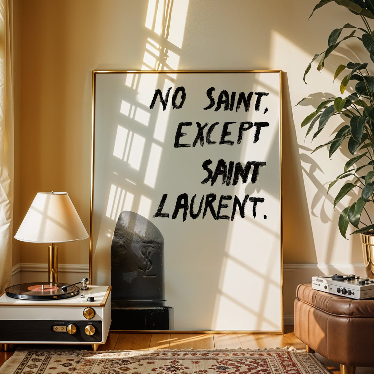 Gray lipstick with black brush lettering quote print shown in a gold frame beside a record player and table lamp