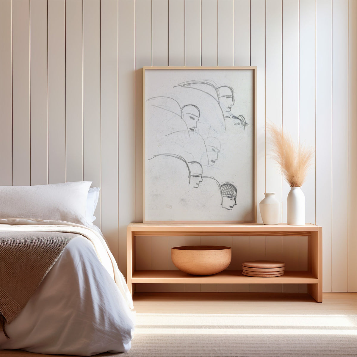 Gray pencil bob hair profiles figure sketch print in a light oak frame on a wood bench by a bed with pampas grass