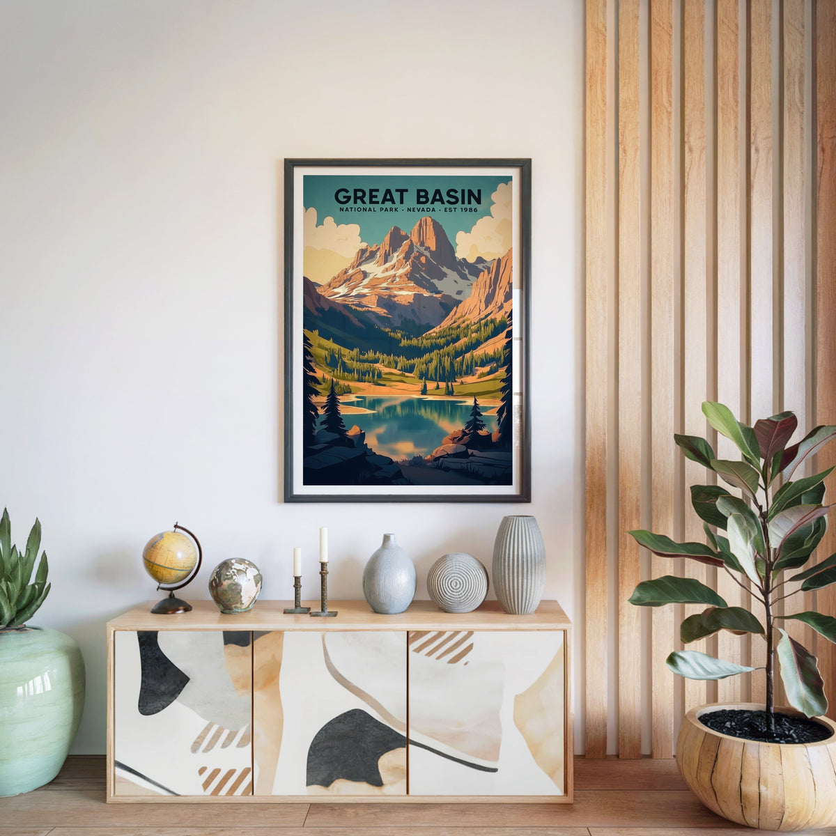 Great Basin National Park print in a black frame above a light wood sideboard with a globe