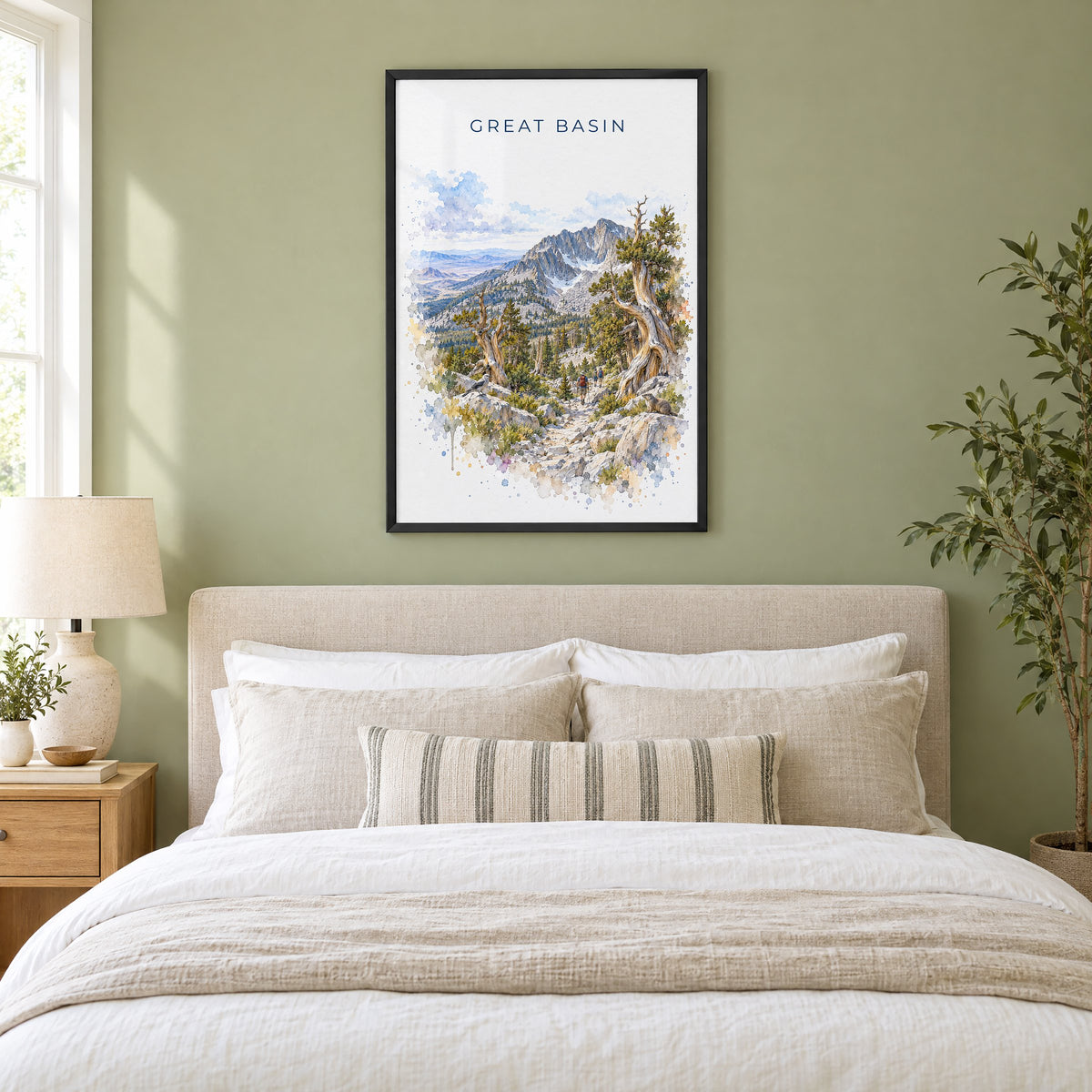 Great Basin National Park watercolor print in a black frame above an upholstered headboard in a sage green bedroom